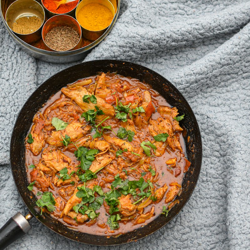 Traditional Nepalese curry served with rice, salad and achar